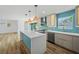 Open kitchen with a large island, stainless steel appliances, and sliding doors to the backyard at 4704 W Fairview Hts, Tampa, FL 33616