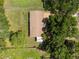 Aerial shot of a home with a large yard and surrounded by trees at 5391 54Th N St, St Petersburg, FL 33709