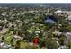 A nice aerial view of a residential neighborhood with lake, mature trees, and nearby community at 5391 54Th N St, St Petersburg, FL 33709