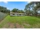 Expansive backyard features a green lawn and partial view of the home's exterior at 5391 54Th N St, St Petersburg, FL 33709