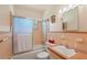 Bathroom featuring a combined shower and tub unit with sliding glass doors and a cream color scheme at 5391 54Th N St, St Petersburg, FL 33709