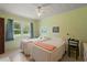 A bedroom with a window, fan, and two twin beds at 5391 54Th N St, St Petersburg, FL 33709