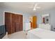 Bedroom with a bed and closet featuring louvered doors, complemented by neutral-colored walls at 5391 54Th N St, St Petersburg, FL 33709