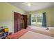 A light filled bedroom with twin beds and a closet at 5391 54Th N St, St Petersburg, FL 33709