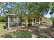 Exterior shot showing a house with a screened patio and grass in the yard at 5391 54Th N St, St Petersburg, FL 33709