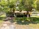 Charming home exterior with a well-manicured front yard and mature tree shading the property at 5391 54Th N St, St Petersburg, FL 33709