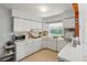 A bright kitchen with white cabinets and appliances at 5391 54Th N St, St Petersburg, FL 33709