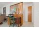 The office has a wooden room divider, desk, and vintage chair at 5391 54Th N St, St Petersburg, FL 33709