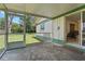An outdoor patio with a metal chair showing the adjacent grassy yard and the home's exterior at 5391 54Th N St, St Petersburg, FL 33709
