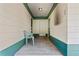 Exterior entryway with a concrete porch, painted accents, and a single seating chair at 5391 54Th N St, St Petersburg, FL 33709