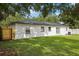 Expansive backyard featuring lush green grass and a freshly painted white exterior at 6 N Orion Ave, Clearwater, FL 33765