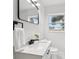 Bathroom featuring a modern vanity with a marble countertop, sleek faucet, and a rectangular mirror at 6 N Orion Ave, Clearwater, FL 33765