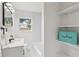 Bathroom featuring a modern vanity with a marble countertop and open shelves for storage at 6 N Orion Ave, Clearwater, FL 33765