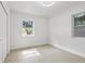 Bright, empty bedroom with neutral walls, light-colored flooring, a closet and two large windows at 6 N Orion Ave, Clearwater, FL 33765