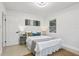 Well-lit bedroom with neutral decor, a cozy bed, and a decorative art piece at 6 N Orion Ave, Clearwater, FL 33765