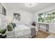Bright bedroom featuring large windows, neutral tones, and a cozy rug at 6 N Orion Ave, Clearwater, FL 33765