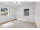 Bright, empty bedroom with neutral walls, light-colored flooring, and two large windows at 6 N Orion Ave, Clearwater, FL 33765