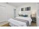 Bright bedroom featuring a comfortable bed, neutral decor, and an adjacent bathroom at 6 N Orion Ave, Clearwater, FL 33765