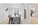 Bright dining room with a modern table set, neutral walls, and access to the kitchen at 6 N Orion Ave, Clearwater, FL 33765