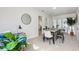 Bright dining room with modern table and decor, with views into other living spaces at 6 N Orion Ave, Clearwater, FL 33765