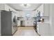 Bright kitchen with white cabinetry, stainless steel appliances, modern lighting, and stylish backsplash at 6 N Orion Ave, Clearwater, FL 33765