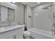 Bright bathroom features a shower and tub with modern fixtures and granite countertops at 6601 121St Ave # I, Largo, FL 33773
