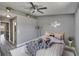 Stylishly furnished bedroom features a ceiling fan, wood-look floors, and neutral wall paint at 6601 121St Ave # I, Largo, FL 33773