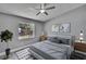 Neutral bedroom with neutral walls, ceiling fan, wood-look flooring and natural light at 6601 121St Ave # I, Largo, FL 33773