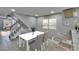 Bright dining area with modern table, chairs, staircase, and stylish decor at 6601 121St Ave # I, Largo, FL 33773