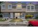 Townhome with neutral paint, walkway to doors, and reserved parking in front at 6601 121St Ave # I, Largo, FL 33773