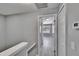 Hallway features neutral paint, wood-look flooring and access to bedrooms at 6601 121St Ave # I, Largo, FL 33773