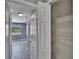 Hallway with shelving and access to a bedroom with overhead lighting and natural light at 6601 121St Ave # I, Largo, FL 33773
