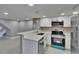 Bright kitchen with stainless steel appliances, breakfast bar, and abundant counter space at 6601 121St Ave # I, Largo, FL 33773