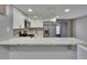 Contemporary kitchen with stainless steel appliances, white cabinets, and stone countertops at 6601 121St Ave # I, Largo, FL 33773