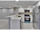 Well-lit kitchen featuring stainless steel appliances, modern countertops, and ample cabinet space at 6601 121St Ave # I, Largo, FL 33773