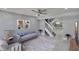Open-concept living area with staircase, comfortable seating, and view of the kitchen at 6601 121St Ave # I, Largo, FL 33773