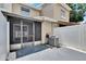 Exterior view of the home with a screened patio, modern AC unit, and white fenced in yard at 6601 121St Ave # I, Largo, FL 33773