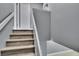 Clean staircase with wood-look steps and white risers, leading to upper level at 6601 121St Ave # I, Largo, FL 33773