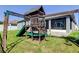 Backyard with a playset and partial view of the covered patio at 6648 Castle Green Pl, Zephyrhills, FL 33541