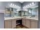 Modern bathroom with dual sinks, vanity, and abundant mirror space at 6648 Castle Green Pl, Zephyrhills, FL 33541