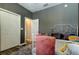 Serene bedroom with ample closet space, cozy bed, and grey walls at 6648 Castle Green Pl, Zephyrhills, FL 33541