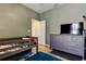 Relaxing bedroom space with wood-look floors, grey walls, dresser, and comfy bed at 6648 Castle Green Pl, Zephyrhills, FL 33541