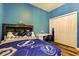 A cozy bedroom with blue Tampa Bay Lightning theme and storage at 6648 Castle Green Pl, Zephyrhills, FL 33541