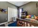 Comfortable bedroom with ample storage, closet, grey walls, and wood-look floors at 6648 Castle Green Pl, Zephyrhills, FL 33541