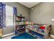 Inviting bedroom with grey walls, wood-look floors, with shelving unit, and comfy bed at 6648 Castle Green Pl, Zephyrhills, FL 33541