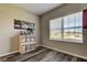 Bedroom with a large window and vinyl floor; ideal for natural light and easy maintenance at 6648 Castle Green Pl, Zephyrhills, FL 33541