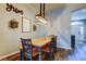 Dining area with a rustic wooden table, chair seating, overhead light, and stylish decor at 6648 Castle Green Pl, Zephyrhills, FL 33541