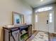 Inviting foyer featuring a decorative storage console, attractive flooring and a bright front door at 6648 Castle Green Pl, Zephyrhills, FL 33541