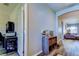 Hallway with hardwood floors, neutral paint, and storage shelves leading into the living space at 6648 Castle Green Pl, Zephyrhills, FL 33541