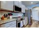 Contemporary kitchen with granite countertops, stainless steel appliances, and modern cabinetry at 6648 Castle Green Pl, Zephyrhills, FL 33541